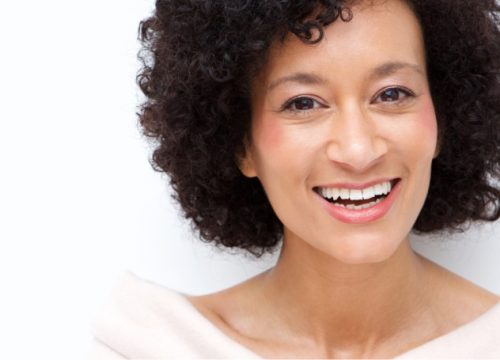 Smiling woman with minor facial volume loss