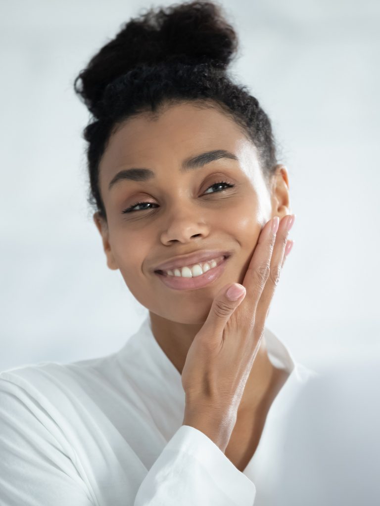 Woman touching her cheek with her hand