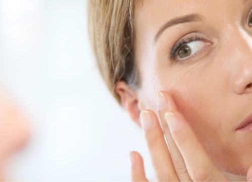 Woman touching her face after Secret RF treatments