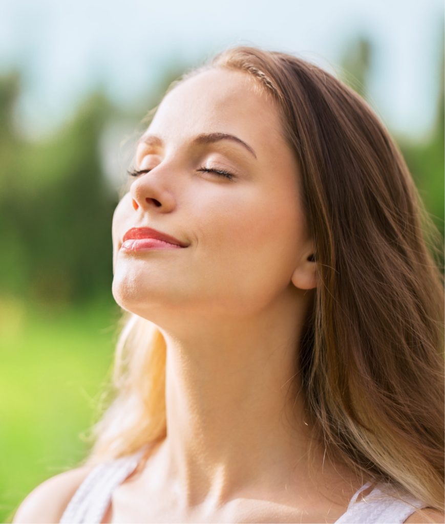 Woman with her chin up and eyes closed